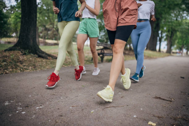istock Female friends jogging in park 1422734779