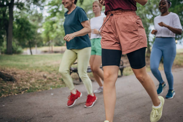 istock Female friends jogging in park 1422734843
