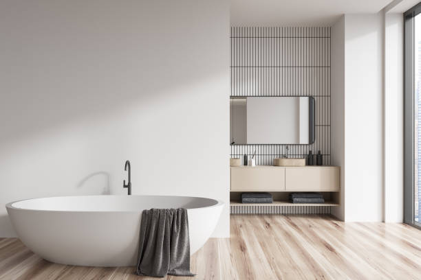 istock Light bathroom interior with bathtub and washbasin near panoramic window. Mockup 1422734863