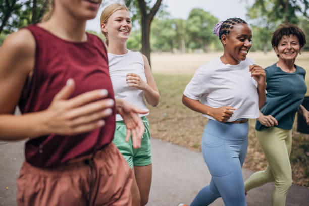 istock Female friends jogging in park 1422734920