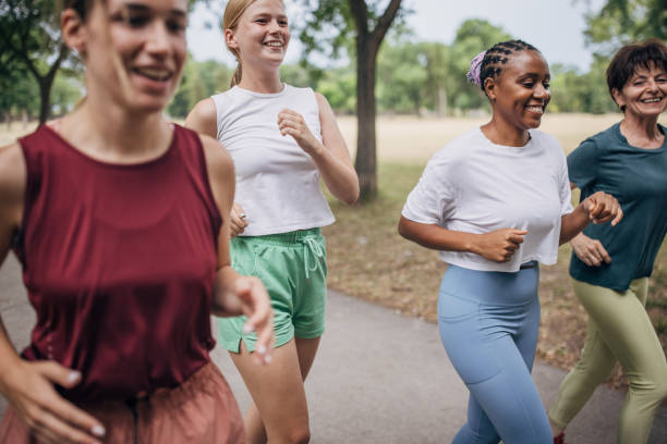 istock Female friends jogging in park 1422735062