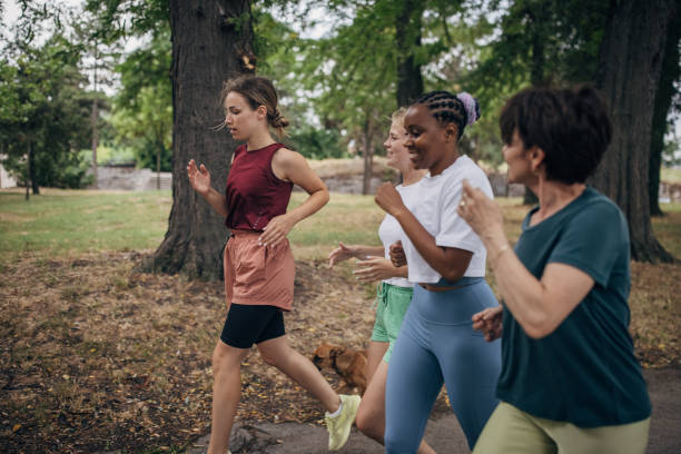 istock Female friends jogging in park 1422735267