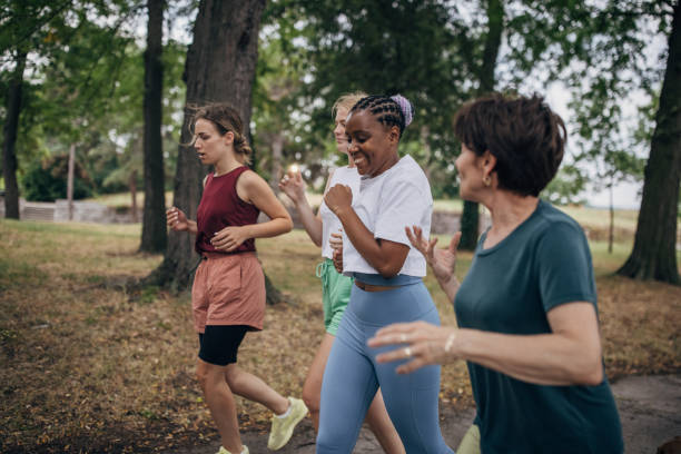 istock Female friends jogging in park 1422735361