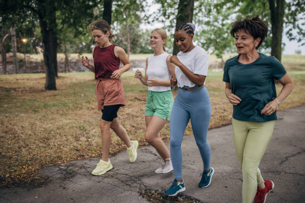 istock Female friends jogging in park 1422735395