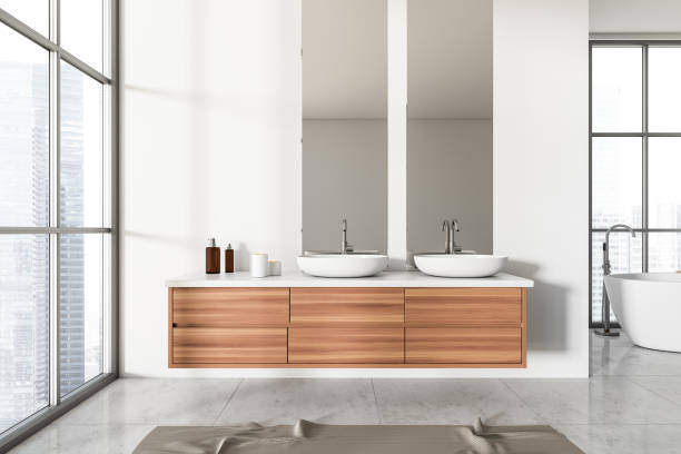 istock Front view on bright bathroom interior with bathtub, two mirrors 1422735987
