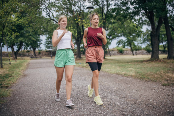 istock Two women jogging in park 1422739492