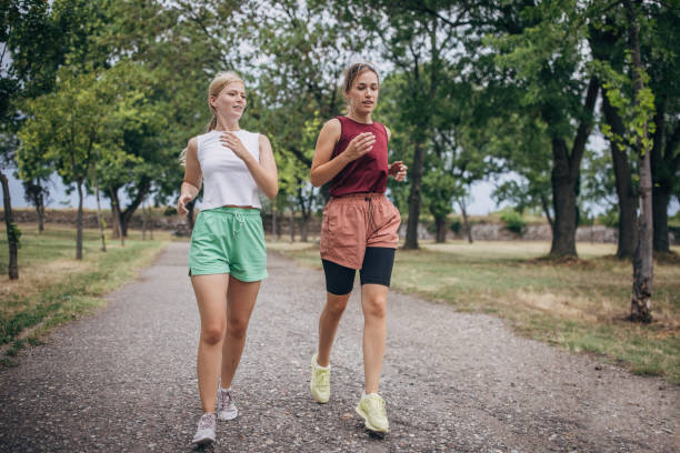 istock Two women jogging in park 1422740051