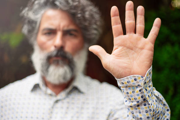 istock Bearded man in casual clothes making stop gesture with his hand 1422741826