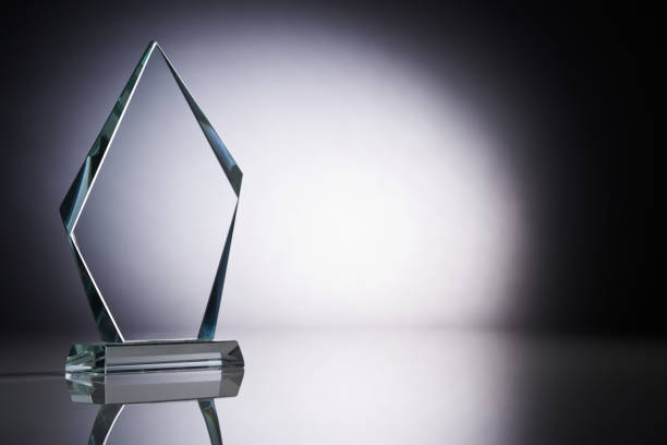 Crystal or glass trophy against gray background