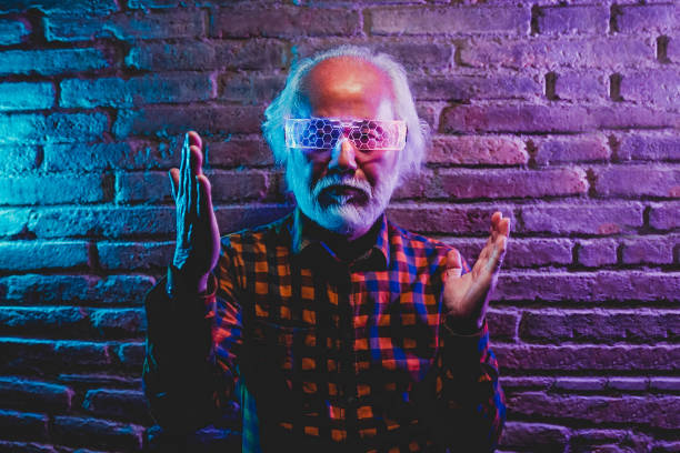istock Senior Asian man dancing and playing with futuristic augmented reality glasses - Metaverse innovation new trend concept 1422746915
