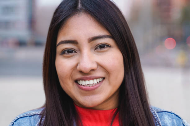 istock Indigenous young woman smiling while looking at camera outdoor - Focus on face 1422746932