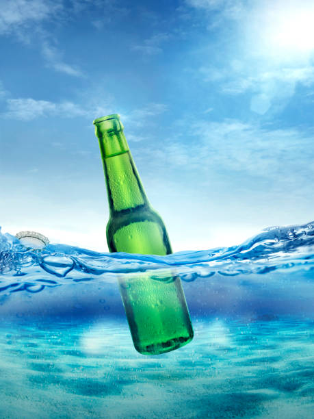 istock Cold wet open beer bottle with smoke floating in the ocean 1422750657