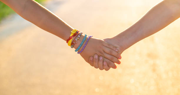 istock Children walk hand in hand. Selective focus. 1422752364