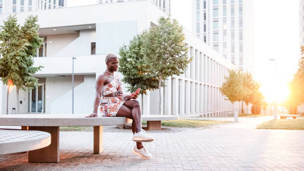 istock Black person using smartphone on street 1422753845