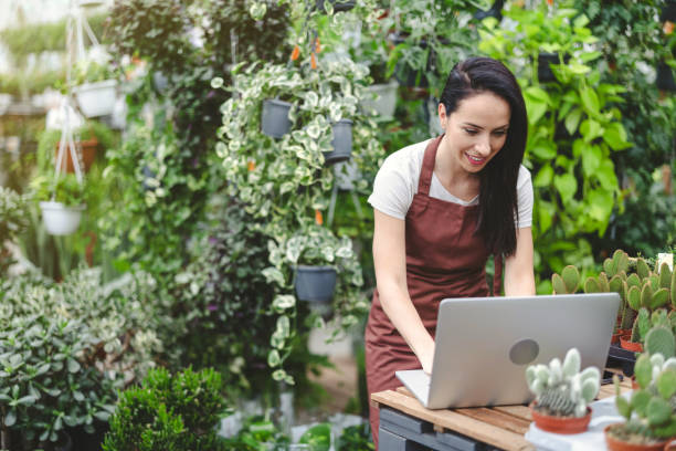 istock Sales Assistant In Garden Center With Laptop 1422754106