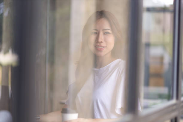 istock Casually dressed Asian woman working on laptop and documents in home office. Work from home concept. 1422755535