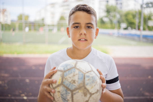 istock Boy soccer player portrait looking at camera 1422755630
