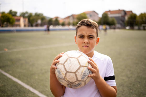 istock Boy soccer player portrait looking at camera 1422756033