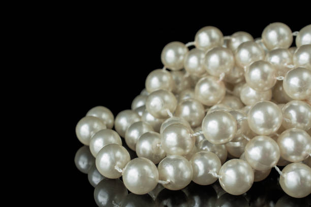 istock Pearl necklace black white elegant image on black 1422756673