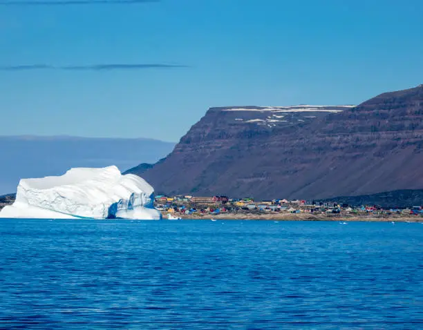 Giant icebergs in front of the city of Qeqertarsuaq, Disko Island,  Disko Bay, Western Greenland