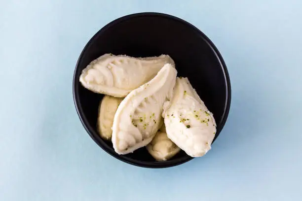 Photo of Durga Puja,Diwali festival special Bengali sweet called Shankh Sandesh or Sondesh or Shondesh on blue background.