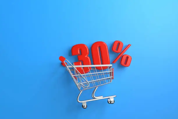 Photo of Glossy red thirty percent Discount Sign in a shopping cart on a blue background