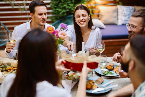istock Cheerful friends talking while enjoying dinner at dining table in party 1422765869