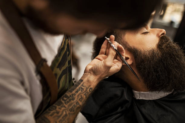 istock Barber styling beard of a customer in barber shop 1422765954