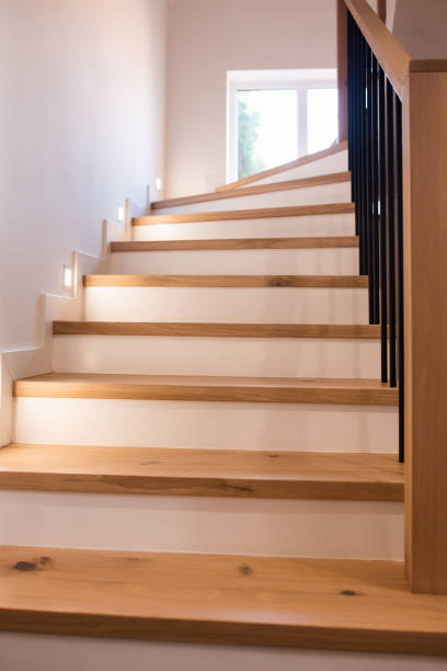 istock Wood staircase inside contemporary white modern house. 1422765974