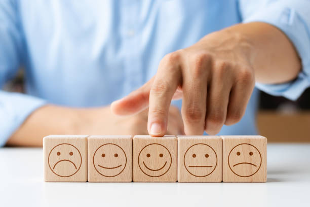 istock Customer satisfaction survey concept, customer hand selects wooden cube with smiley face icon, best service excellence rating for satisfaction. 1422766492