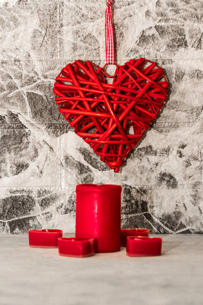 istock Rattan work of heart shape with red candles on grey background wall 1422767535