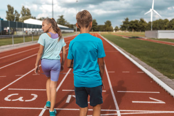 istock Two athletic children working hard on the running track 1422770773