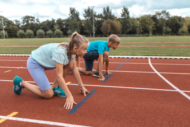 istock Two athletic children working hard on the running track 1422770873