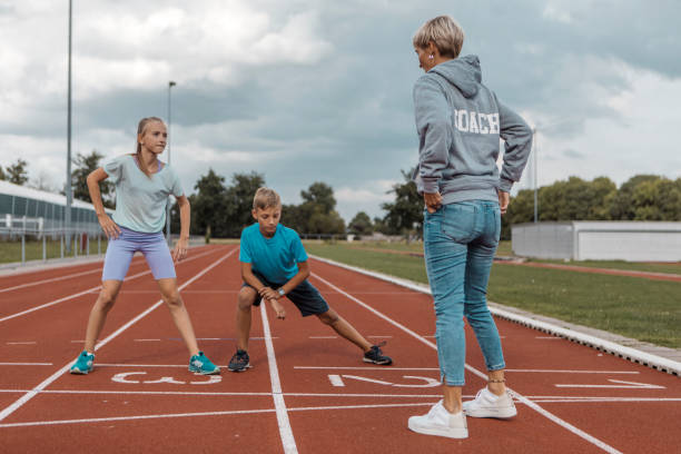 istock Athletics mother running coach working with her children during a training session 1422770880