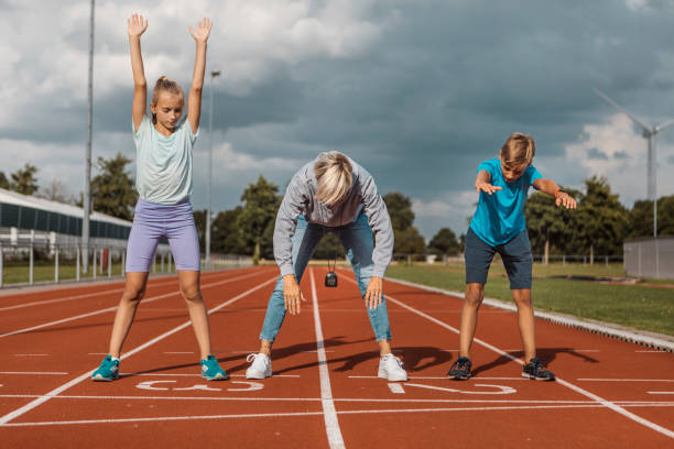 istock Athletics mother running coach working with her children during a training session 1422770888