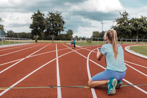 Two athletic children working hard on the running track