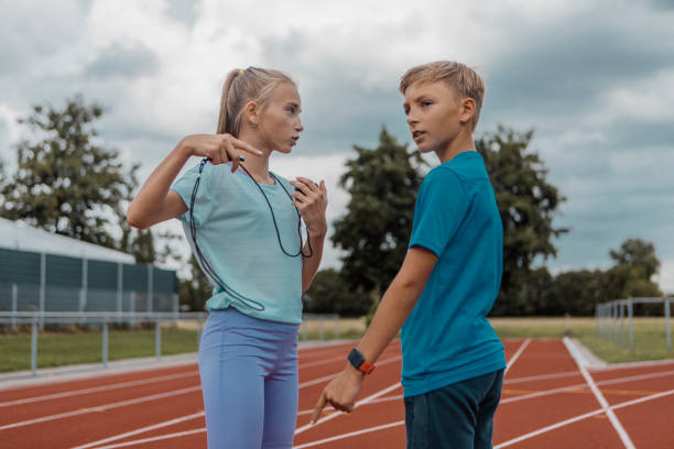 istock Two athletic children working hard on the running track 1422770936