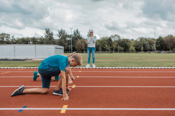 istock Two athletic children working hard on the running track 1422770972