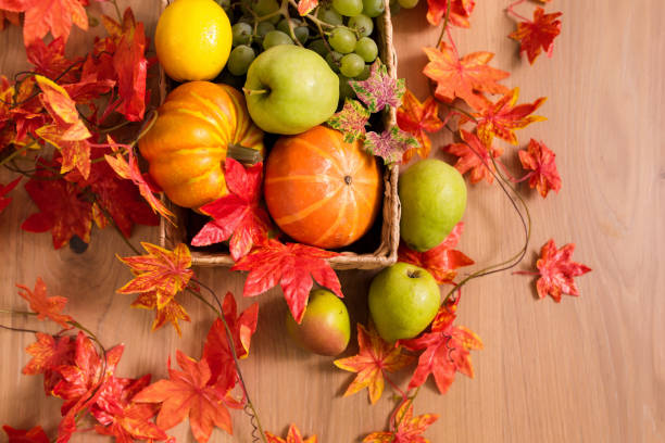 istock Peaceful Fall Fruit, Leaf, Acorn Still Life Arrangement on Wood Board Table Background with room or space for copy, text, your words. 1422771780