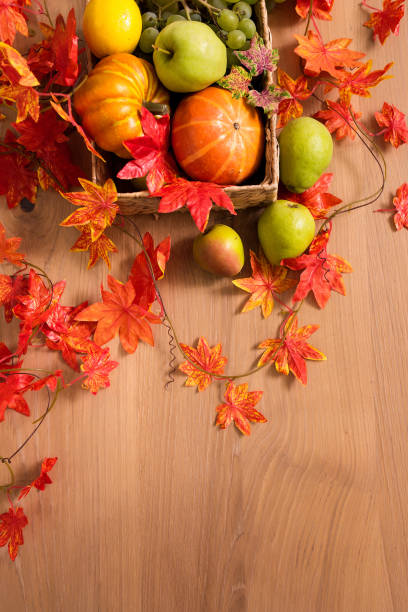 istock Peaceful Fall Fruit, Leaf, Acorn Still Life Arrangement on Wood Board Table Background with room or space for copy, text, your words. 1422771829