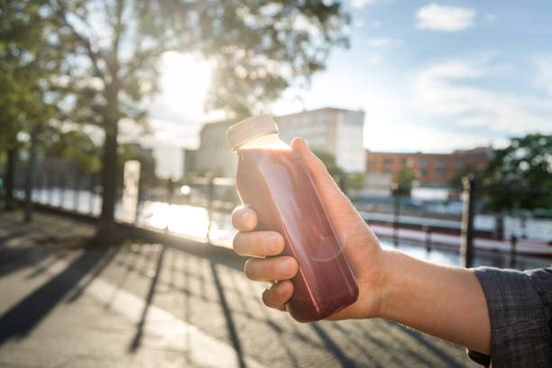 Man holding a plastic bottle with smoothie