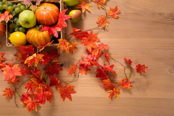 istock Peaceful Fall Fruit, Leaf, Acorn Still Life Arrangement on Wood Board Table Background with room or space for copy, text, your words. 1422771929