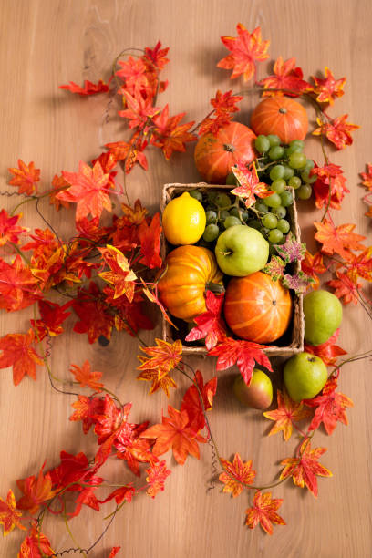 istock Peaceful Fall Fruit, Leaf, Acorn Still Life Arrangement on Wood Board Table Background with room or space for copy, text, your words. 1422771964