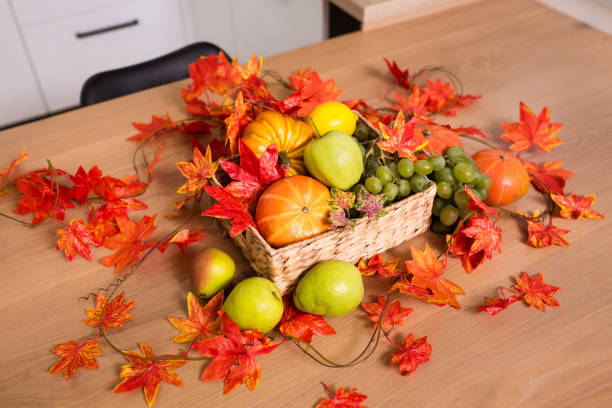 istock Peaceful Fall Fruit, Leaf, Acorn Still Life Arrangement on Wood Board Table Background with room or space for copy, text, your words. 1422772009