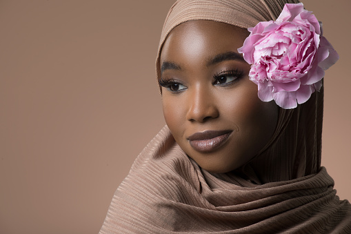 Portrait of a Beautiful Muslim Woman wearing hijab in a studio shot