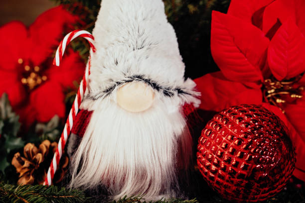istock Christmas composition with gnome and festive decorations on wooden background. 1422775503