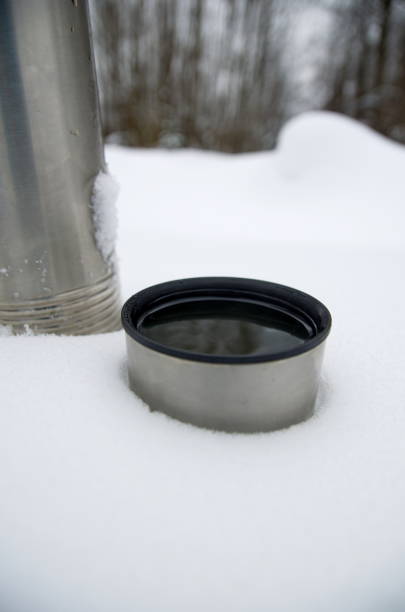 istock Winter tourism. Thermos in the snow. 1422778522