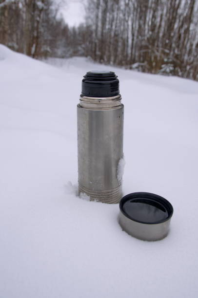 istock Winter tourism. Thermos in the snow. 1422778524