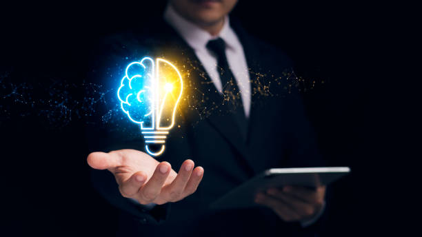 istock Businessman holding a virtual bulb and half-brain, innovation through ideas and ideas that inspire smart thinking. 1422780120
