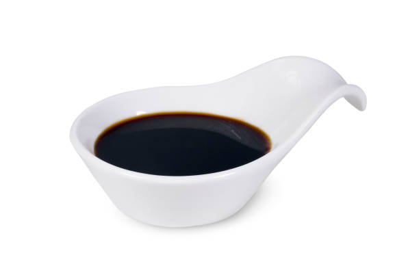 Soy sauce in bowl isolated on white background Soy sauce in bowl isolated on white background soia sauce stock pictures, royalty-free photos & images